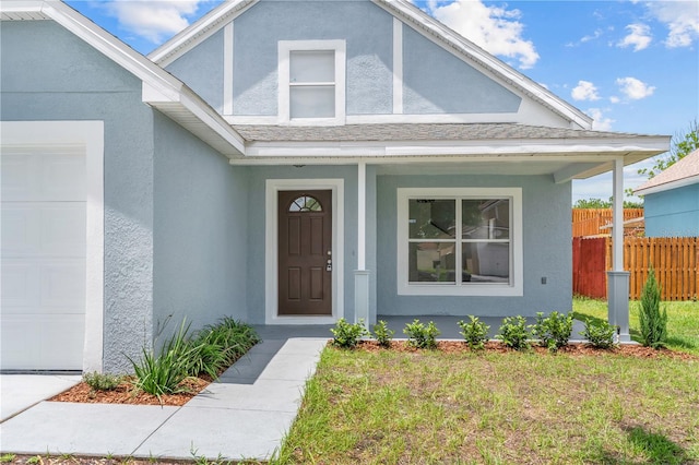 view of exterior entry with a garage