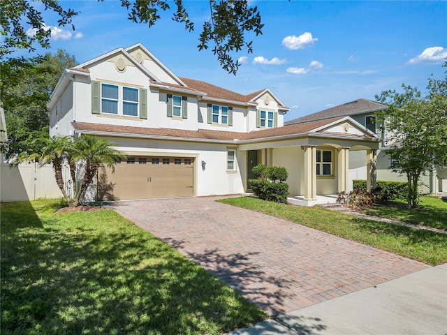 view of front of property with a garage and a front yard