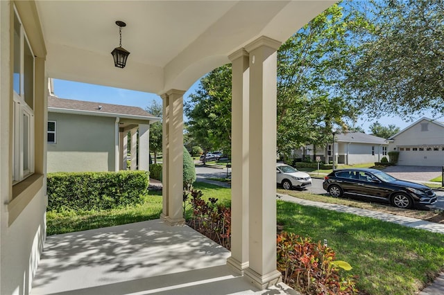 view of patio with covered porch and a garage