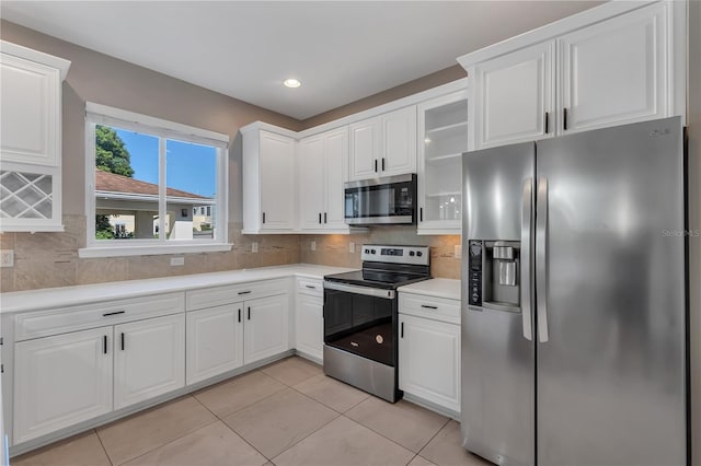 kitchen featuring light tile patterned floors, tasteful backsplash, and stainless steel appliances