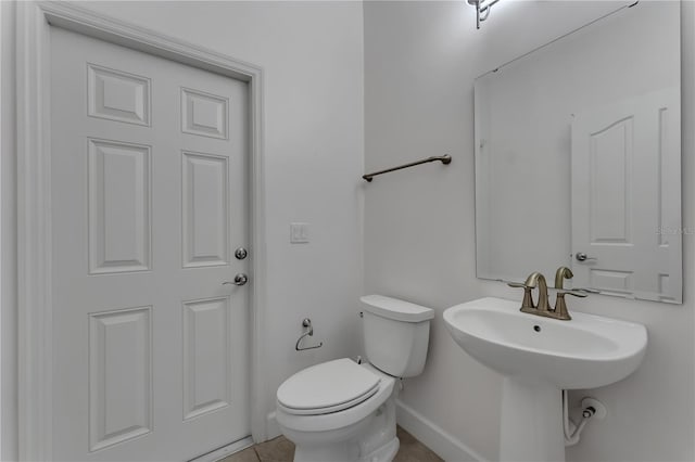 bathroom with tile patterned floors and toilet