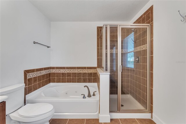 full bathroom featuring plus walk in shower, vanity, tile patterned floors, and toilet