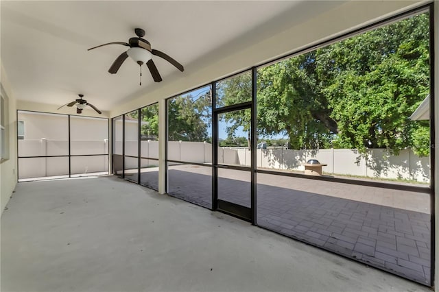 unfurnished sunroom featuring ceiling fan