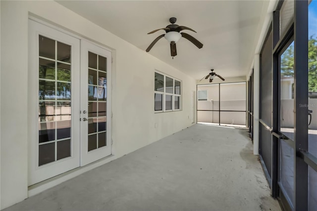 unfurnished sunroom featuring french doors and ceiling fan