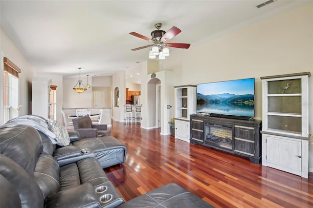 living room with dark hardwood / wood-style flooring and ceiling fan