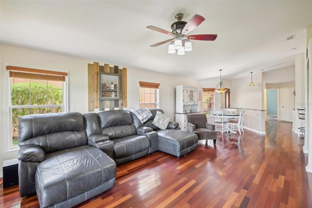 living room with plenty of natural light, dark hardwood / wood-style floors, and ceiling fan