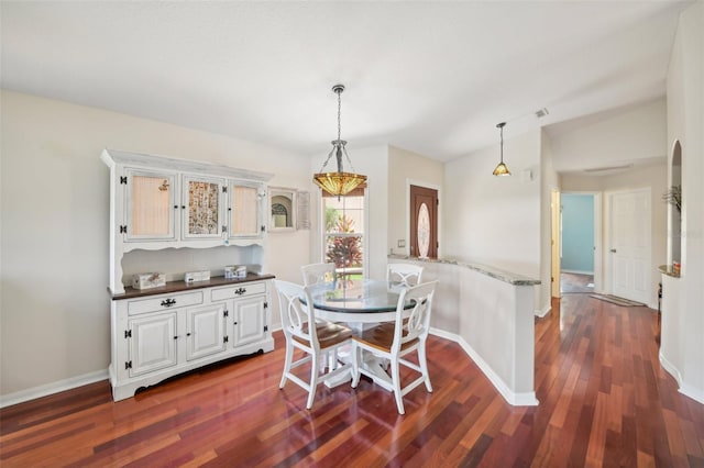 dining room with dark hardwood / wood-style floors