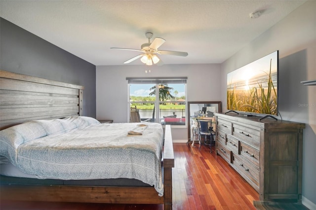 bedroom featuring ceiling fan, wood-type flooring, and a textured ceiling