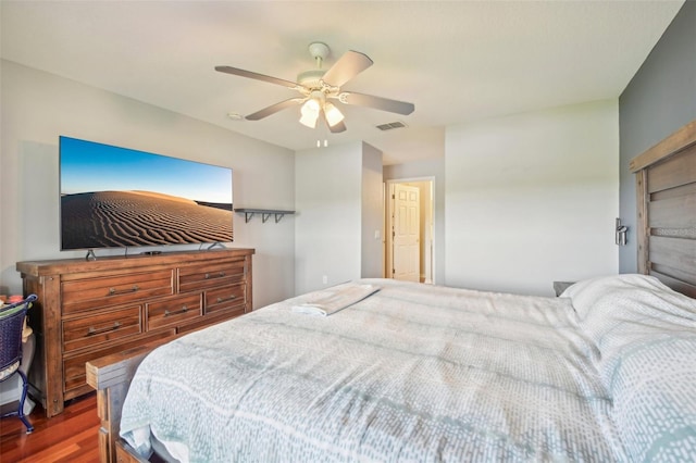 bedroom with dark hardwood / wood-style flooring and ceiling fan