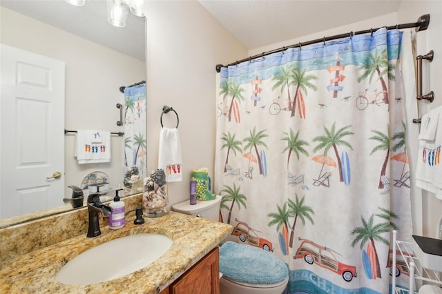 bathroom featuring vanity, toilet, and a shower with shower curtain