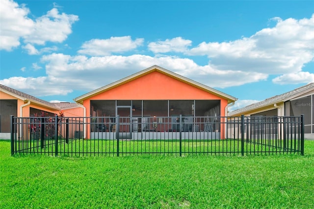 back of property with a sunroom and a yard