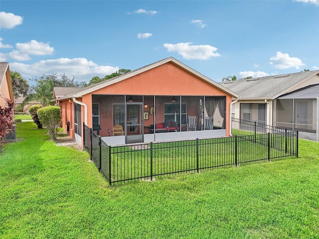 back of property featuring a lawn and a sunroom