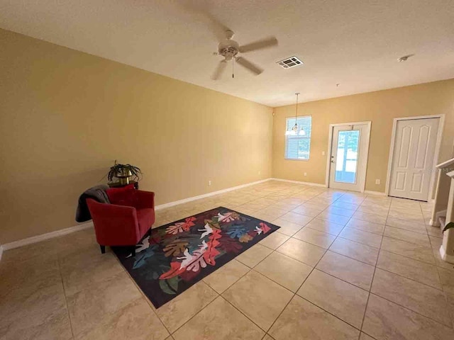 interior space featuring light tile patterned flooring and ceiling fan