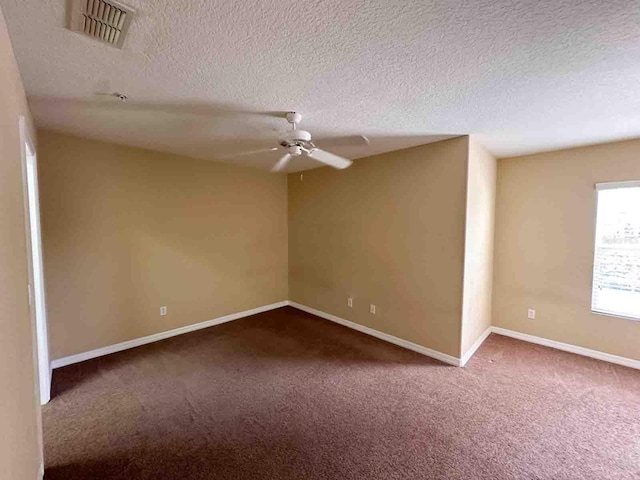 carpeted empty room featuring a textured ceiling and ceiling fan