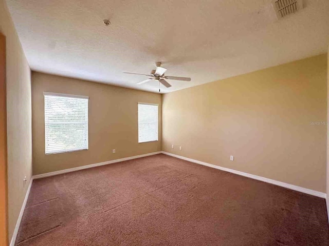 unfurnished room with ceiling fan and carpet floors