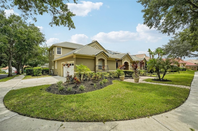 view of front of home featuring a front lawn and a garage