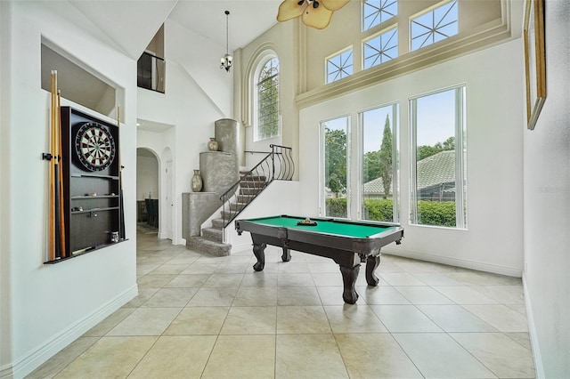 game room with light tile patterned floors, billiards, a high ceiling, and plenty of natural light