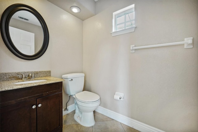 bathroom featuring vanity, toilet, and tile patterned flooring