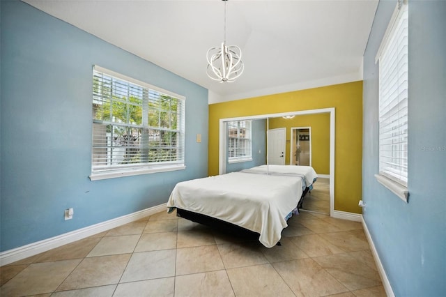 tiled bedroom with a notable chandelier