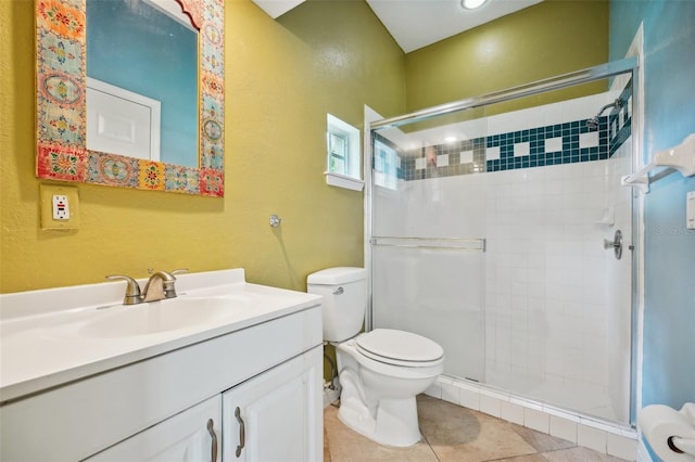 bathroom with toilet, vanity, tile patterned flooring, and an enclosed shower