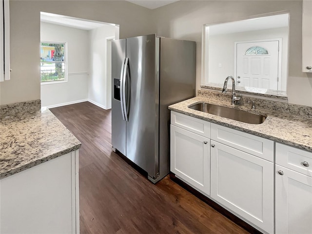 kitchen with sink, white cabinets, and light stone counters