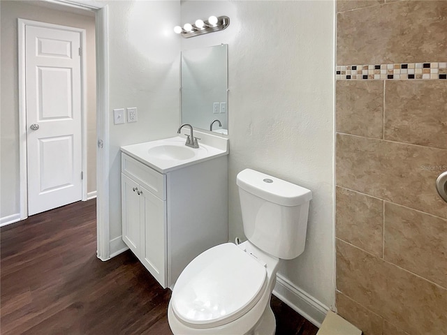 bathroom with vanity, wood-type flooring, and toilet