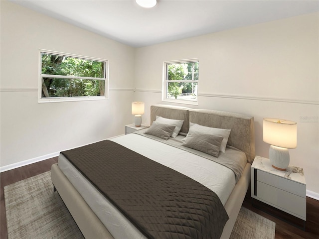 bedroom featuring dark wood-type flooring and lofted ceiling