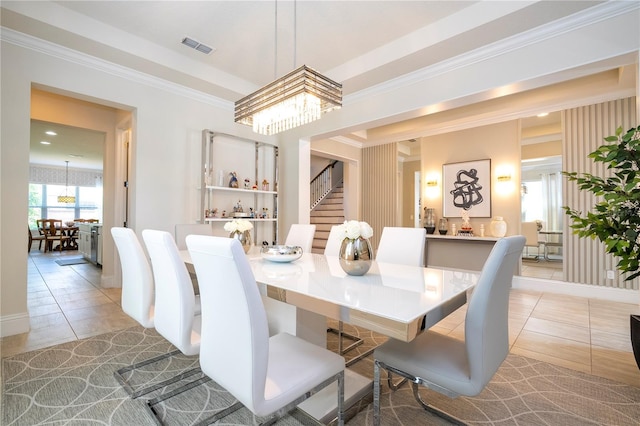 dining area with light tile patterned flooring, a chandelier, and ornamental molding