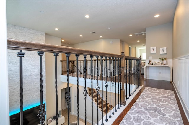 hallway with hardwood / wood-style flooring