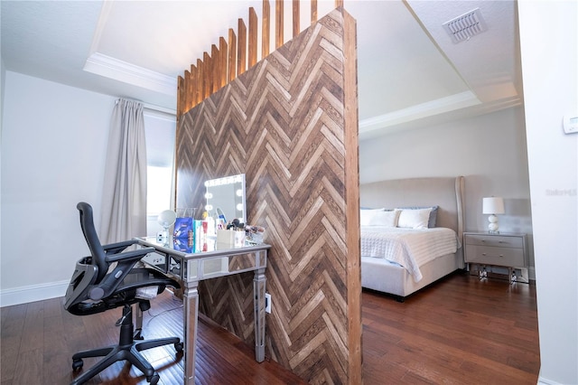 bedroom with dark hardwood / wood-style floors and a tray ceiling