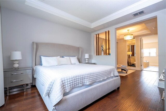 bedroom featuring dark wood-type flooring, crown molding, and a raised ceiling