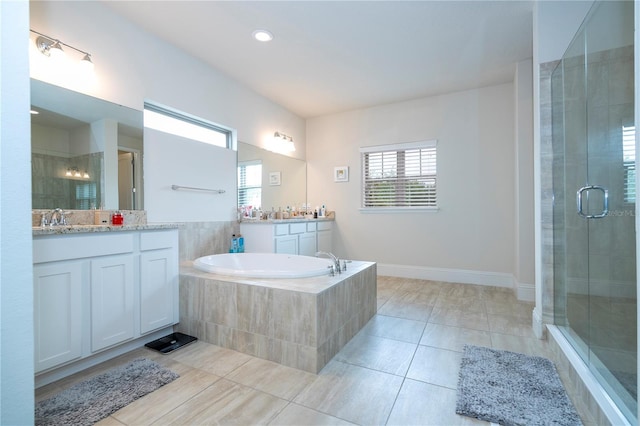 bathroom featuring independent shower and bath, tile patterned floors, and vanity