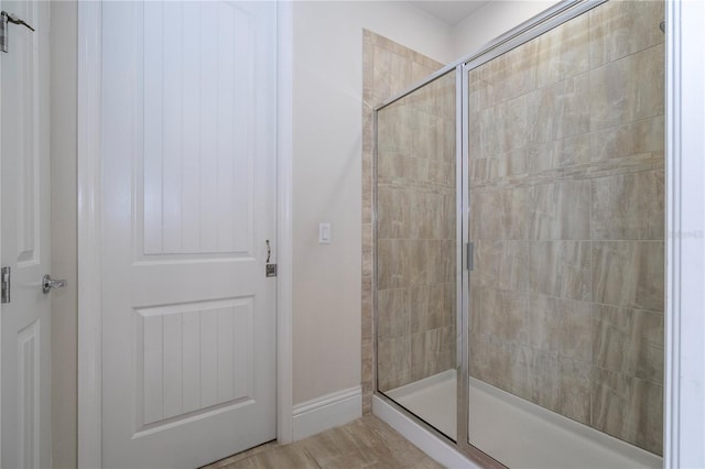 bathroom featuring a shower with shower door