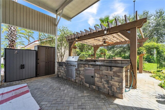 view of patio / terrace featuring a pergola, an outdoor kitchen, an outdoor wet bar, and a grill