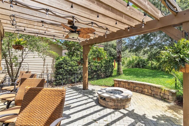 view of patio / terrace featuring a pergola, ceiling fan, and an outdoor fire pit