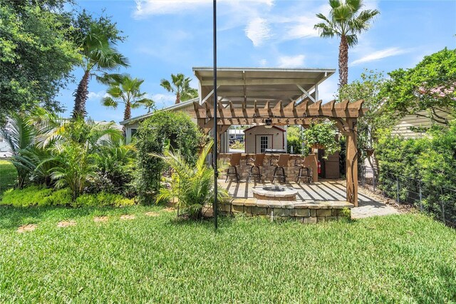 view of yard with ceiling fan and an outdoor fire pit