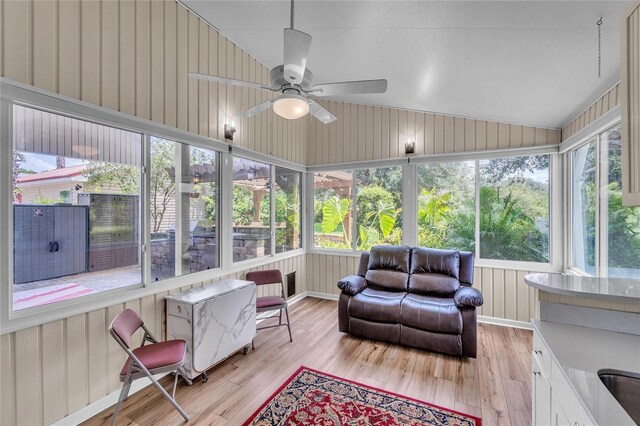 sunroom / solarium featuring lofted ceiling and ceiling fan