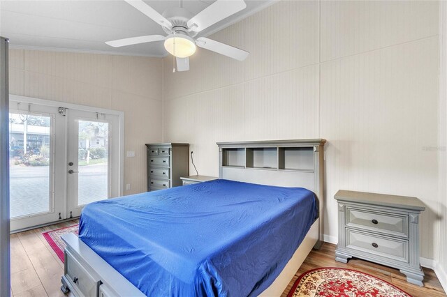 bedroom with access to exterior, french doors, light wood-type flooring, lofted ceiling, and ceiling fan