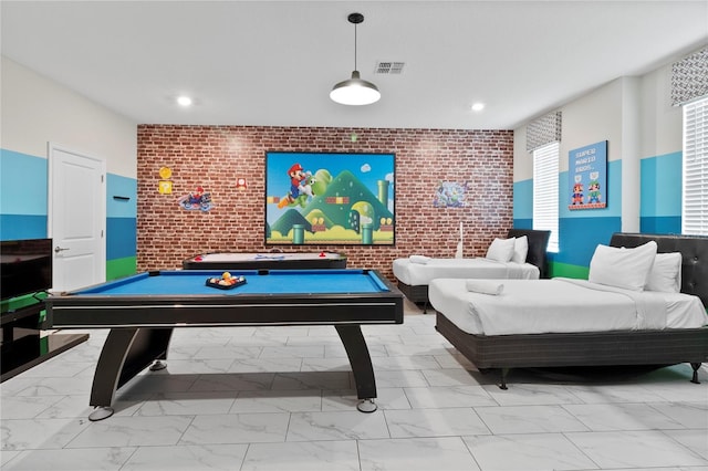 recreation room with brick wall