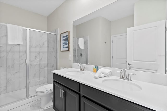 bathroom with vanity, toilet, and a shower with shower door