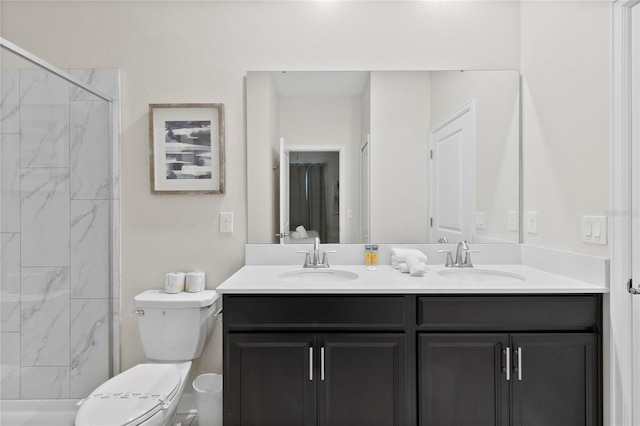 bathroom featuring vanity, tiled shower, and toilet