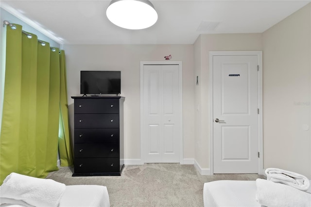 carpeted bedroom with a closet