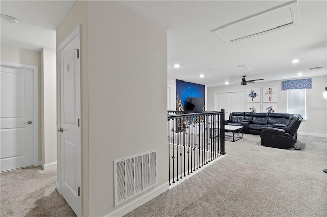 hallway featuring light colored carpet