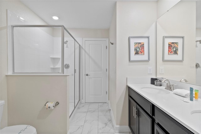 bathroom with vanity, an enclosed shower, and toilet