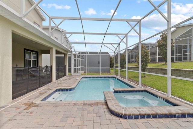 view of pool with an in ground hot tub, a lanai, a yard, and a patio area