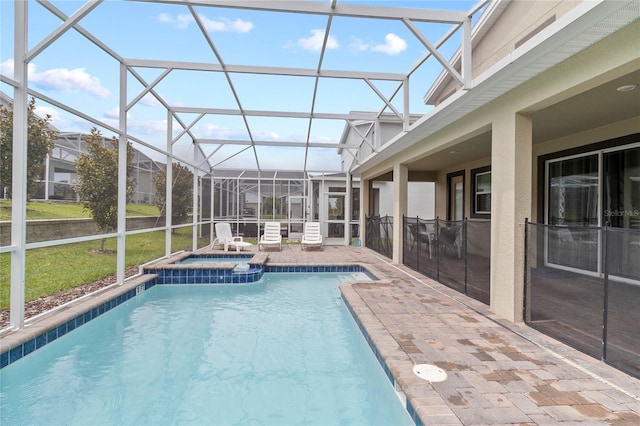 view of swimming pool featuring an in ground hot tub, a patio, and glass enclosure