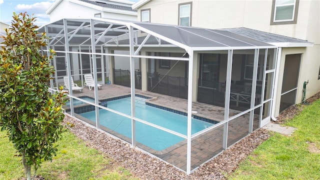 view of pool featuring a patio and glass enclosure