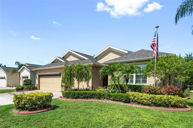 view of front of property with a garage and a front yard