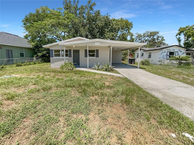 view of front of property with a carport and a front yard