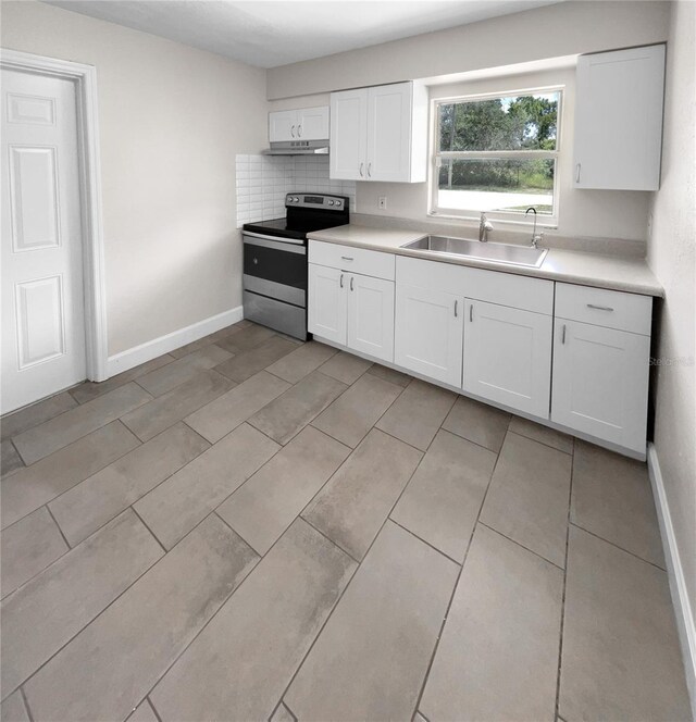 kitchen with stainless steel range with electric stovetop, sink, decorative backsplash, and white cabinets